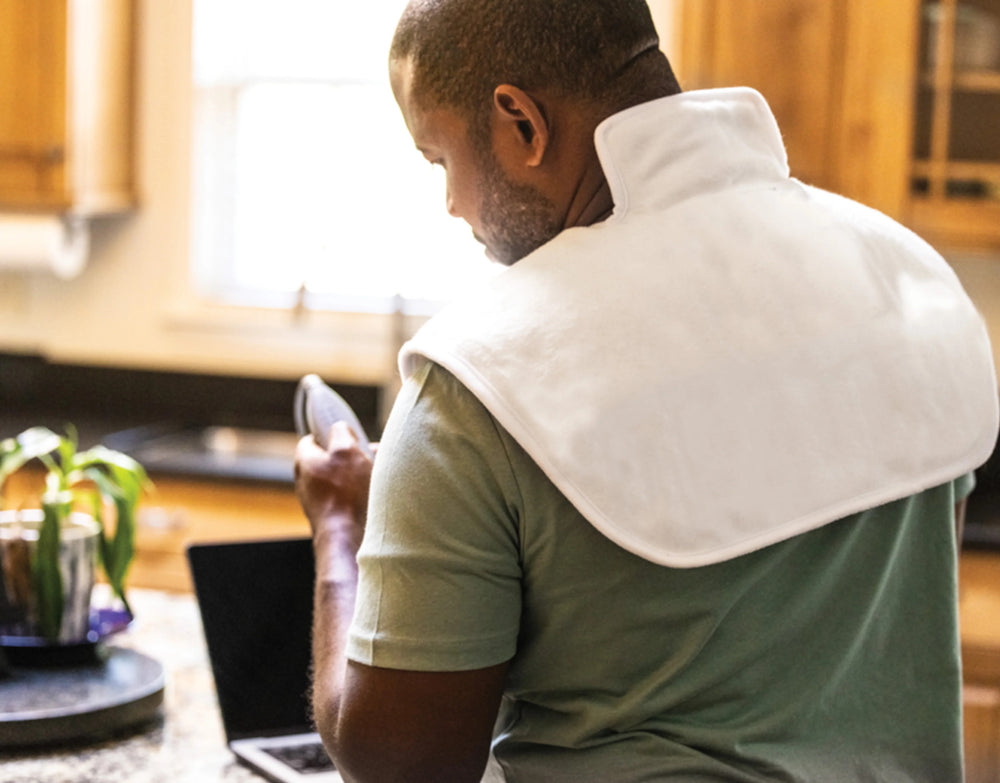 Man using the Thermophore MaxHEAT Neck & Shoulders Moist Heat Therapy Pad