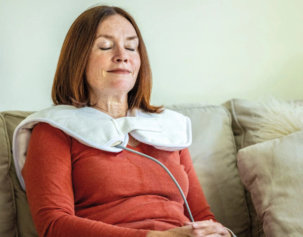 Woman using the Thermophore MaxHEAT Neck & Shoulders Moist Heat Therapy Pad