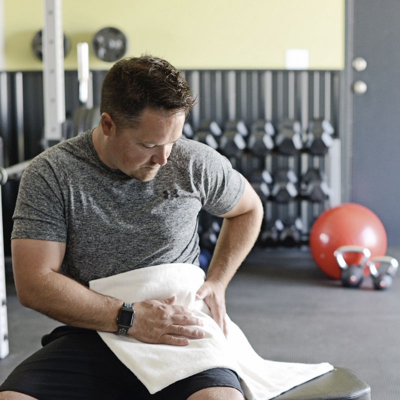 Man using Thermophore MaxHEAT moist heating pad at the gym